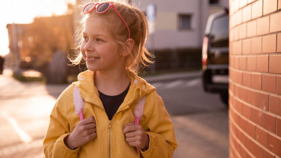 A smiling kid talking with her mother